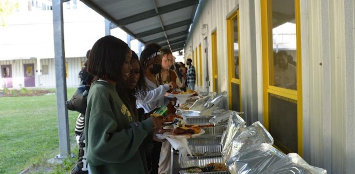 Students and staff alike filling up their plates for the Launch Party bbq